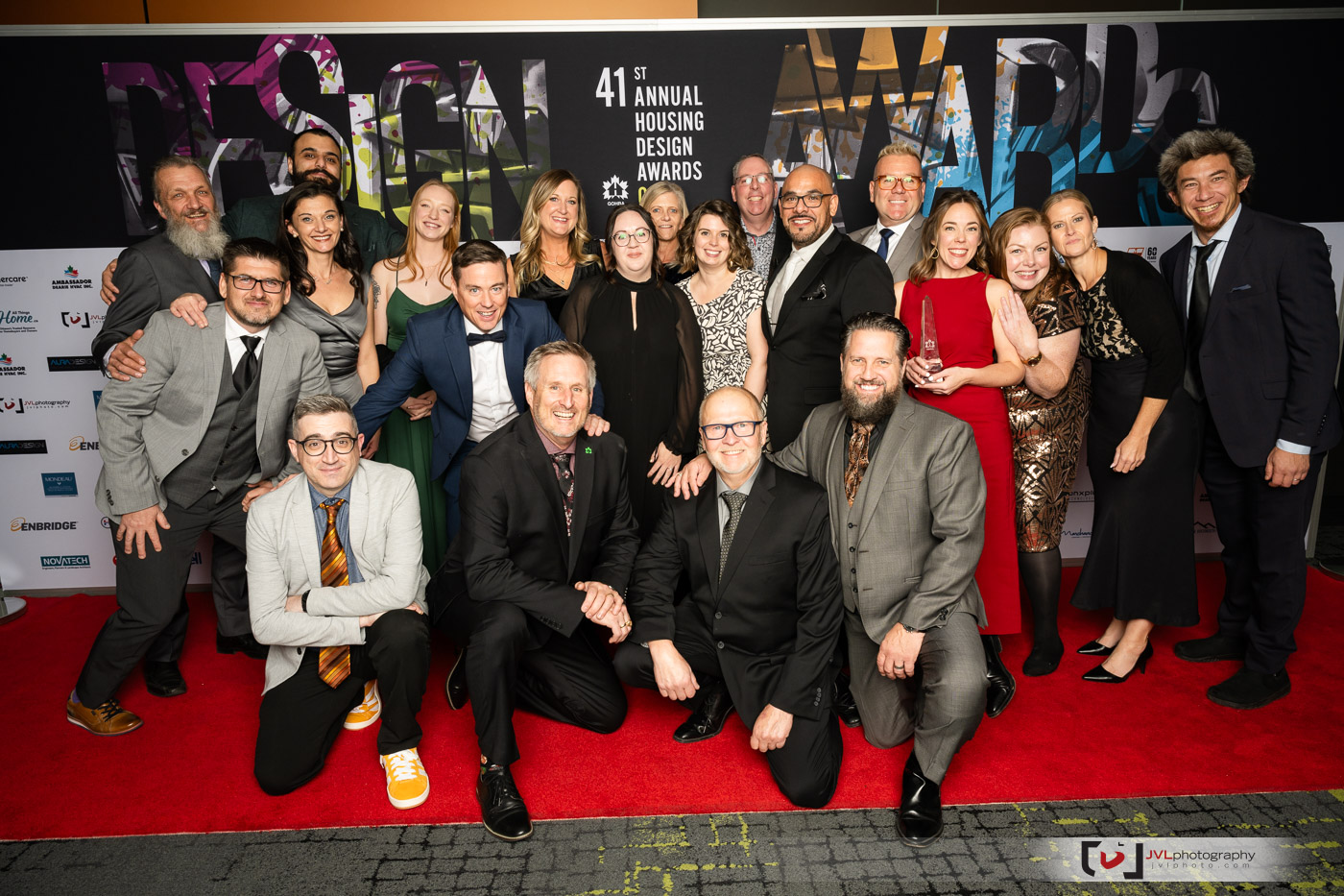 The Amsted Team stands together on a red carpet at the GOHBA Awards, capturing a moment of success and unity in a glamorous setting.